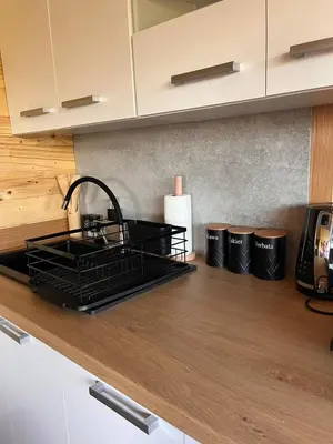 a kitchen with a sink and a counter top at Domki- Limanowa domek 4 domek z jacuzzi i sauną in Limanowa