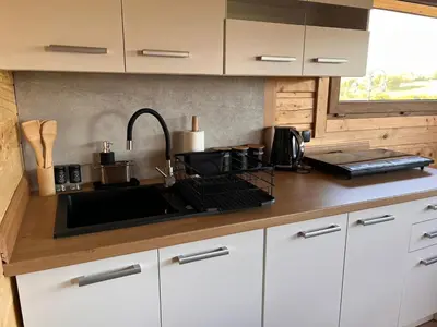 a white refrigerator with a microwave on top of it at Domki- Limanowa domek 4 domek z jacuzzi i sauną in Limanowa