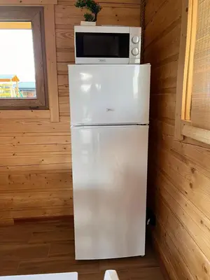 a kitchen and dining room of a tiny house at Domki- Limanowa domek 4 domek z jacuzzi i sauną in Limanowa