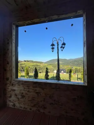 a window in a room with a view of a street light at Domki- Limanowa domek 4 domek z jacuzzi i sauną in Limanowa