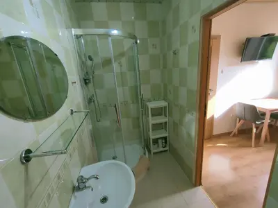 a bathroom with a glass shower and a sink at Pokoje gościnne Zawoja Centrum Henryk Hadka in Zawoja