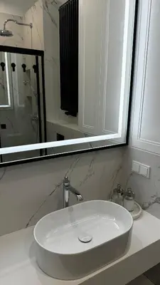 a bathroom with a white sink and a mirror at Cracow Apartments & Self check in & Free Parking in Kraków