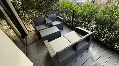 a patio with a table and chairs on a deck at Cracow Apartments & Self check in & Free Parking in Kraków