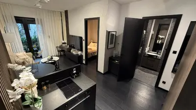 a room with a living room with a bedroom at Cracow Apartments & Self check in & Free Parking in Kraków