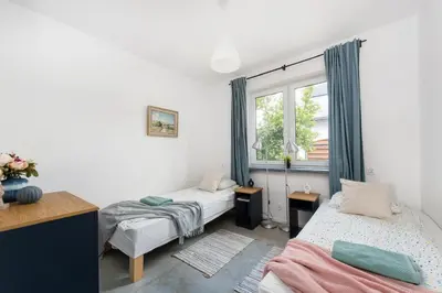 a bedroom with two beds and a window at Yellow villa in Zator