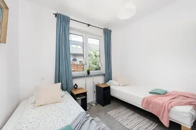a bedroom with two beds and a window at Yellow villa in Zator