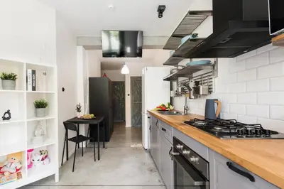 a kitchen with a counter and a stove top oven at Yellow villa in Zator