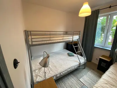 a bedroom with a bunk bed with a lamp on it at Yellow villa in Zator