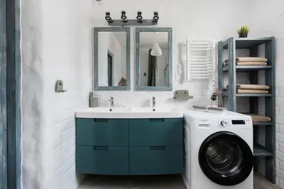a bathroom with a washing machine and a sink at Yellow villa in Zator