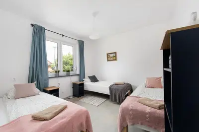 a bedroom with two beds and a window at Yellow villa in Zator
