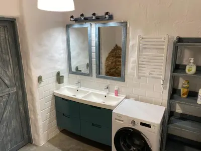 a bathroom with a sink and a washing machine at Yellow villa in Zator