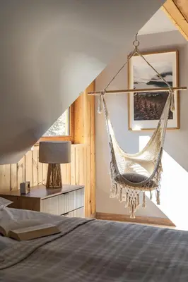 a bedroom with two beds in a attic at Polana Słowikowa 5 star- domek w górach z jacuzzi, sauna,basen,ogród z lasem, kominek i narty in Stróża