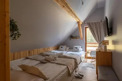 a log cabin with a table and a pool at Polana Słowikowa 5 star- domek w górach z jacuzzi, sauna,basen,ogród z lasem, kominek i narty in Stróża