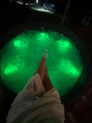 a swimming pool with a towel sitting on a chair at Polana Słowikowa 5 star- domek w górach z jacuzzi, sauna,basen,ogród z lasem, kominek i narty in Stróża
