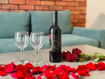a bottle of wine and two wine glasses on a table at Apartament Bulwary 36 in Oświęcim
