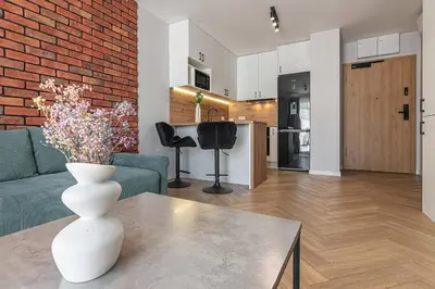 a living room with a vase of flowers on a table at Apartament Bulwary 36 in Oświęcim