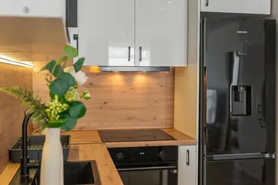 a kitchen with a vase of flowers on the counter at Apartament Bulwary 36 in Oświęcim