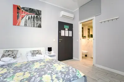a bedroom with a bed and a bathroom at K12 Apartments in Kraków