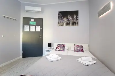 a bedroom with a bed with two towels on it at K12 Apartments in Kraków