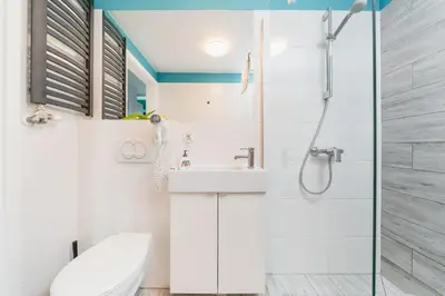 a bathroom with a shower and a toilet and a sink at K12 Apartments in Kraków
