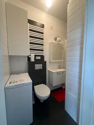 a small bathroom with a toilet and a sink at Kujawska apartment in Kraków