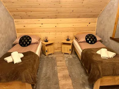 a room with two beds and two night stands at Leśne Zacisze & Spa na wyłączność in Lubień