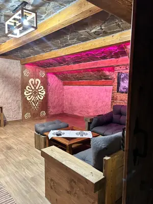 a room with a couch and a table at Leśne Zacisze & Spa na wyłączność in Lubień