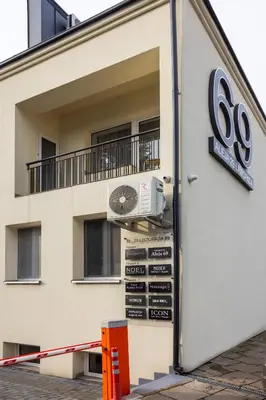 a building with a sign on the side of it at Aleja 69 Premium in Kraków