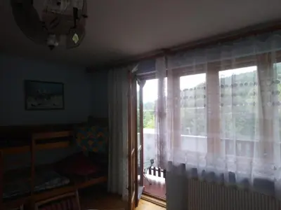 a living room with a couch and a chair at Agroturystyka Boguska in Zawoja