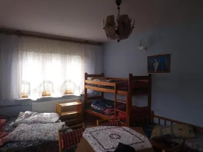 a room with a bed and a closet and a door at Agroturystyka Boguska in Zawoja