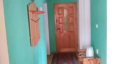 a room with a bed and a table and a window at Agroturystyka Boguska in Zawoja