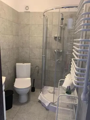 a kitchen with a sink and a microwave at Krakstop apartamenty in Kraków