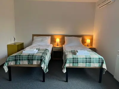 a room with two beds and a desk in it at Krakstop apartamenty in Kraków