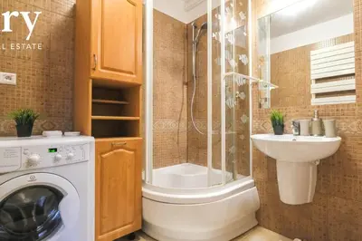 a bathroom with a washing machine and a sink at Big cozy apartment Free 1 parking in Kraków