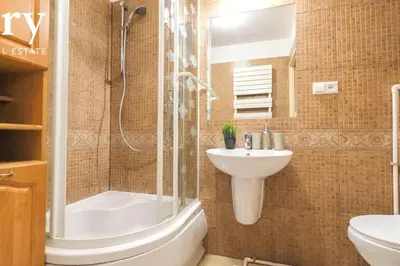 a bathroom with a shower and a sink and a toilet at Big cozy apartment Free 1 parking in Kraków