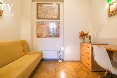 a living room with a couch and a desk at Big cozy apartment Free 1 parking in Kraków