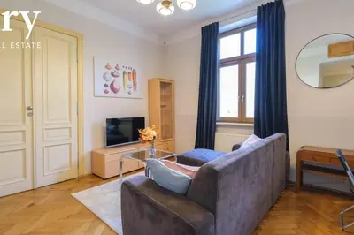 a living room with a couch and a glass table at Big cozy apartment Free 1 parking in Kraków