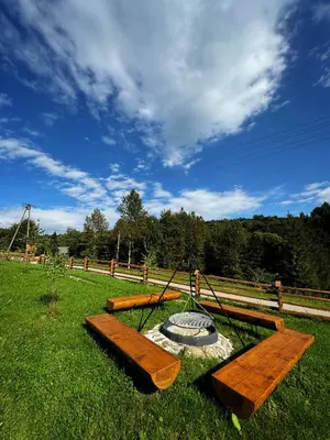 a park with two benches and a swing at Słoneczne Wzgórze w Kojszówce in Kojszówka