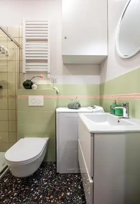 a bathroom with a toilet and a sink at Pastell Apartments in Kraków
