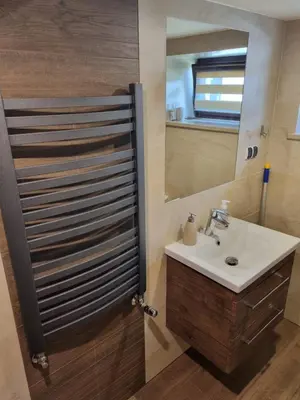 a bathroom with a sink and a mirror at Pokoje jacuzzi in Zator