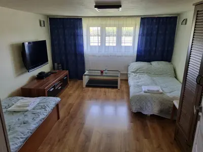 a living room with two beds and a television at Pokoje jacuzzi in Zator