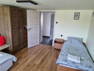 a bedroom with a bed and a door to a hallway at Pokoje jacuzzi in Zator