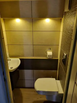 a small bathroom with a toilet and a sink at Pokoje jacuzzi in Zator