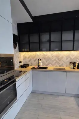 a kitchen with white cabinets and a stove at Apartament nad Wisłą in Kraków