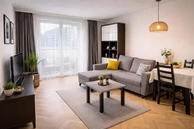 a living room with a couch and a table at Krakow Avenu 29 november 2 room in Kraków