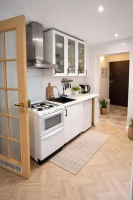 a kitchen with a white stove and a sink at Krakow Avenu 29 november 2 room in Kraków