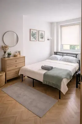 a bedroom with a large bed and a mirror at Krakow Avenu 29 november 2 room in Kraków