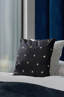 a black pillow with gold butterflies on a bed at Lux Kraków Apartment with Parking & AC just 1,5 km from Main Square by Renters Prestige in Kraków