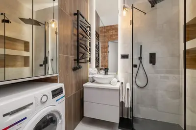 a laundry room with a washer and dryer at Lux Kraków Apartment with Parking & AC just 1,5 km from Main Square by Renters Prestige in Kraków