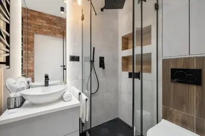 a bathroom with a sink and a shower at Lux Kraków Apartment with Parking & AC just 1,5 km from Main Square by Renters Prestige in Kraków